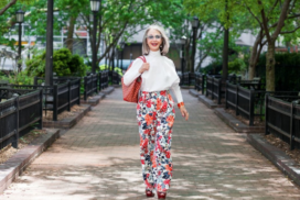 Image of Honey Good walking in floral pants and a white blouse